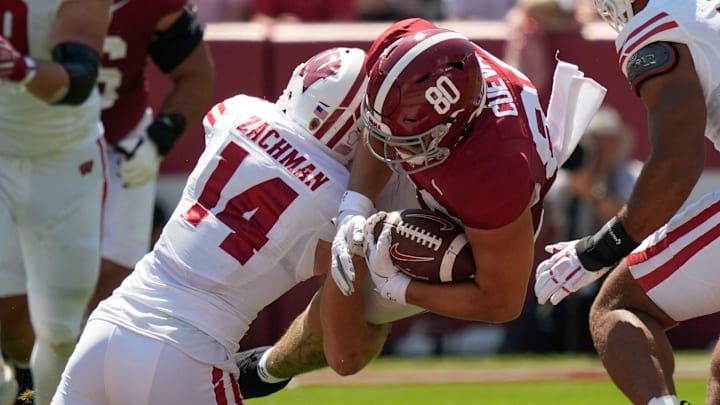 Sep 13, 2025; Tuscaloosa, Alabama, USA; Wisconsin defensive back Preston Zachman (14) makes a tackle on Alabama tight end Josh Cuevas (80) at Saban Field at Bryant-Denny Stadium.