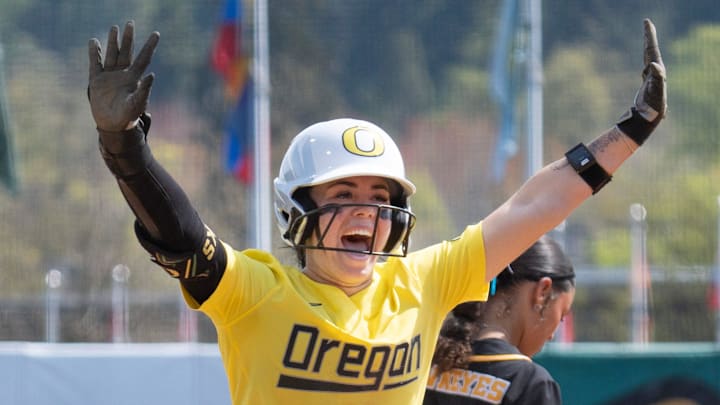 Oregon’s Kaylynn Jones celebrates her triple as she heads home on a throwing error by Iowa in the 6th inning at Jane Sanders Stadium in Eugene April 5, 2026.