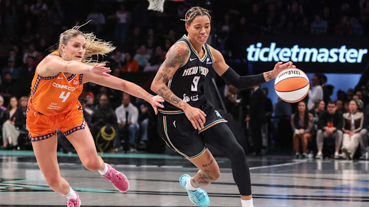 May 9, 2025; Brooklyn, NY, USA;  New York Liberty guard Natasha Cloud (9) drives past Connecticut Sun guard Jacey Sheldon (4) in the first quarter at Barclays Center. Mandatory Credit: Wendell Cruz-Imagn Images