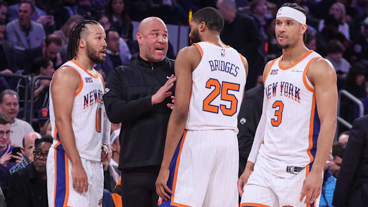 Feb 8, 2025; New York, New York, USA;  New York Knicks assistant coach Rick Brunson talks with New York Knicks guard Jalen Brunson (11), forward Mikal Bridges (25), and guard Josh Hart (3) during a timeout in the third quarter against the Boston Celtics at Madison Square Garden. Mandatory Credit: Wendell Cruz-Imagn Images