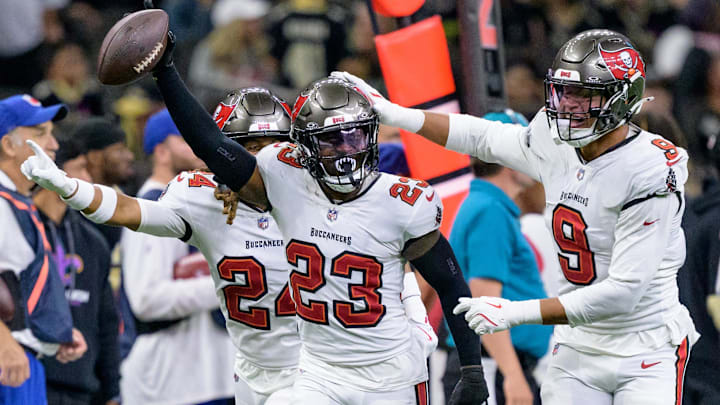 Oct 13, 2024; New Orleans, Louisiana, USA; Tampa Bay Buccaneers safety Tykee Smith (23) celebrates an interception of a ball intended for New Orleans Saints wide receiver Rashid Shaheed (22) with cornerback Tyrek Funderburk (24) and linebacker Joe Tryon-Shoyinka (9) during the fourth quarter at Caesars Superdome. Mandatory Credit: Matthew Hinton-Imagn Images