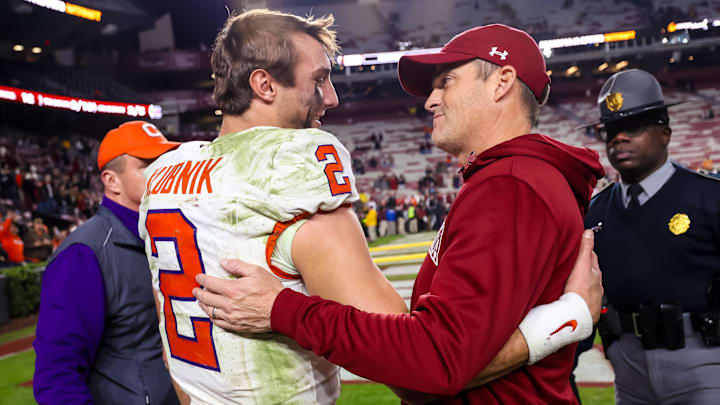 Nov 25, 2023; Columbia, South Carolina, USA; Clemson Tigers quarterback Cade Klubnik (2) and South Carolina Gamecocks head coach Shane Beamer meet after a Tigers victory at Williams-Brice Stadium. Mandatory Credit: Jeff Blake-Imagn Images