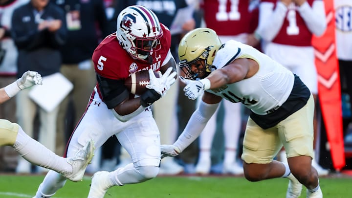 Nov 23, 2024; Columbia, South Carolina, USA; South Carolina Gamecocks running back Raheim Sanders (5) runs the ball against Wofford Terriers defensive back Javis Mynatt (11) in the first quarter at Williams-Brice Stadium. Mandatory Credit: Jeff Blake-Imagn Images Nov 23, 2024; Columbia, South Carolina, USA; South Carolina Gamecocks running back Raheim Sanders (5) runs the ball against Wofford Terriers defensive back Javis Mynatt (11) in the first quarter at Williams-Brice Stadium. Mandatory Credit: Jeff Blake-Imagn Images