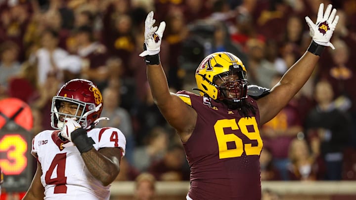 Oct 5, 2024; Minneapolis, Minnesota, USA; Minnesota Golden Gophers offensive lineman Aireontae Ersery (69) celebrates quarterback Max Brosmer's (16) touchdown against the USC Trojans during the first half at Huntington Bank Stadium.