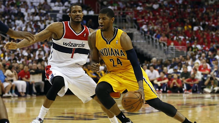 May 15, 2014; Washington, DC, USA; Indiana Pacers forward Paul George (24) dribbles the ball as Washington Wizards forward Trevor Ariza (1) defends in the second quarter in game six of the second round of the 2014 NBA Playoffs at Verizon Center. Mandatory Credit: Geoff Burke-Imagn Images
