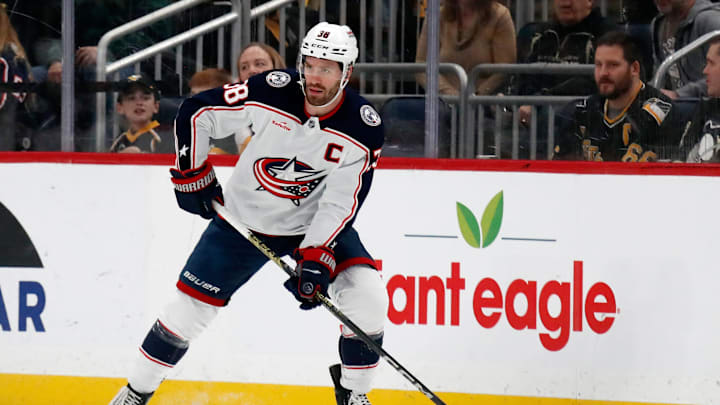 Mar 28, 2024; Pittsburgh, Pennsylvania, USA;  Columbus Blue Jackets center Boone Jenner (38) handles the puck against the Pittsburgh Penguins during the first period at PPG Paints Arena. Mandatory Credit: Charles LeClaire-Imagn Images