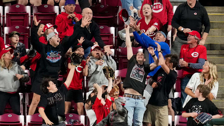 Fans reach for a home run ball off the bat of Cincinnati Reds shortstop Elly de la Cruz (44) in the eighth inning of the MLB Interleague game between the Cincinnati Reds and the Los Angeles Angels at Great American Ball Park in downtown Cincinnati on Friday, April 10, 2026. The Angels won 10-2. Fans reach for a home run ball off the bat of Cincinnati Reds shortstop Elly de la Cruz (44) in the eighth inning of the MLB Interleague game between the Cincinnati Reds and the Los Angeles Angels at Great American Ball Park in downtown Cincinnati on Friday, April 10, 2026. The Angels won 10-2.