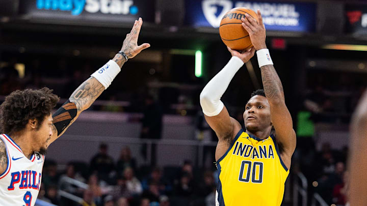 Jan 18, 2025; Indianapolis, Indiana, USA; Indiana Pacers guard Bennedict Mathurin (00) shoots the ball while Philadelphia 76ers guard Kelly Oubre Jr. (9) defends in the first half at Gainbridge Fieldhouse. Mandatory Credit: Trevor Ruszkowski-Imagn Images