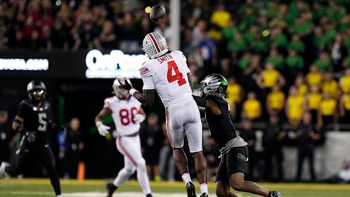 Oct 12, 2024; Eugene, Oregon, USA; Ohio State Buckeyes wide receiver Jeremiah Smith (4) makes a catch against Oregon Ducks defensive back Jabbar Muhammad (7) in the second half during the NCAA football game at Autzen Stadium.