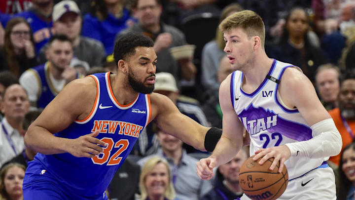 Mar 11, 2026; Salt Lake City, Utah, USA; New York Knicks center/forward Karl-Anthony Towns (32) defends on Utah Jazz center Kyle Filipowski (22) during the first half at Delta Center. Mandatory Credit: Peter Creveling-Imagn Images