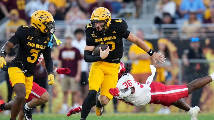 ASU Sun Devils quarterback Sam Leavitt (10) scrambles out of the backfield against the Houston Cougars at Mountain America Stadium in Tempe on Oct. 25, 2025. ASU Sun Devils quarterback Sam Leavitt (10) scrambles out of the backfield against the Houston Cougars at Mountain America Stadium in Tempe on Oct. 25, 2025.