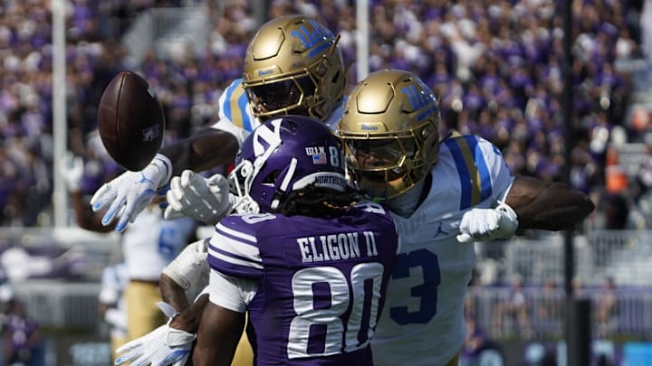 Sep 27, 2025; Evanston, Illinois, USA;UCLA Bruins defensive back Key Lawrence (4) and defensive back Robert Stafford III (3) defends Northwestern Wildcats wide receiver Hayden Eligon II (80) during the first half at Northwestern Medicine Field at Martin Stadium. Mandatory Credit: David Banks-Imagn Images Sep 27, 2025; Evanston, Illinois, USA;UCLA Bruins defensive back Key Lawrence (4) and defensive back Robert Stafford III (3) defends Northwestern Wildcats wide receiver Hayden Eligon II (80) during the first half at Northwestern Medicine Field at Martin Stadium. Mandatory Credit: David Banks-Imagn Images