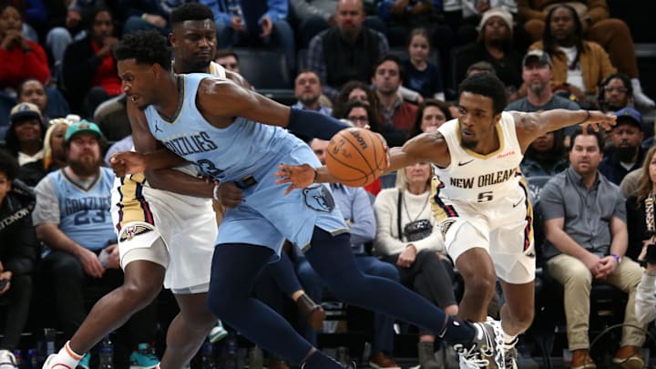 Feb 12, 2024; Memphis, Tennessee, USA; New Orleans Pelicans forward Herbert Jones (5) steals the ball from Memphis Grizzlies forward-center Jaren Jackson Jr. (13) as New Orleans Pelicans forward Zion Williamson (1) defends during the second half at FedExForum. Feb 12, 2024; Memphis, Tennessee, USA; New Orleans Pelicans forward Herbert Jones (5) steals the ball from Memphis Grizzlies forward-center Jaren Jackson Jr. (13) as New Orleans Pelicans forward Zion Williamson (1) defends during the second half at FedExForum.
