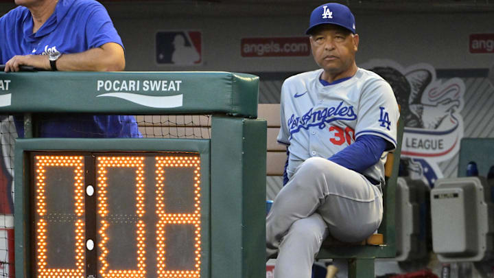 Sep 3, 2024; Anaheim, California, USA;  Los Angeles Dodgers manager Dave Roberts (30) looks on from the dugout against the Los Angeles Angels at Angel Stadium. Mandatory Credit: Jayne Kamin-Oncea-Imagn Images