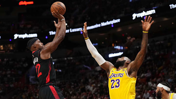 Nov 6, 2023; Miami, Florida, USA; Miami Heat forward Jimmy Butler (22) shoots over Los Angeles Lakers forward LeBron James (23) during the first half at Kaseya Center. 