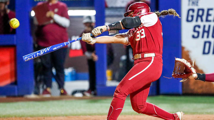 Oklahoma utility Alyssa Brito (33) hits a foul ball in the fifth inning during the first game of the