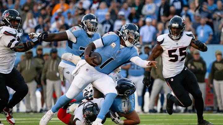 Nov 16, 2025; Nashville, Tennessee, USA; Tennessee Titans quarterback Cameron Ward (1) stiff arms Houston Texans defensive tackle Mario Edwards Jr. (97) during the second half during the second half at Nissan Stadium. Mandatory Credit: Steve Roberts-Imagn Images Nov 16, 2025; Nashville, Tennessee, USA; Tennessee Titans quarterback Cameron Ward (1) stiff arms Houston Texans defensive tackle Mario Edwards Jr. (97) during the second half during the second half at Nissan Stadium. Mandatory Credit: Steve Roberts-Imagn Images
