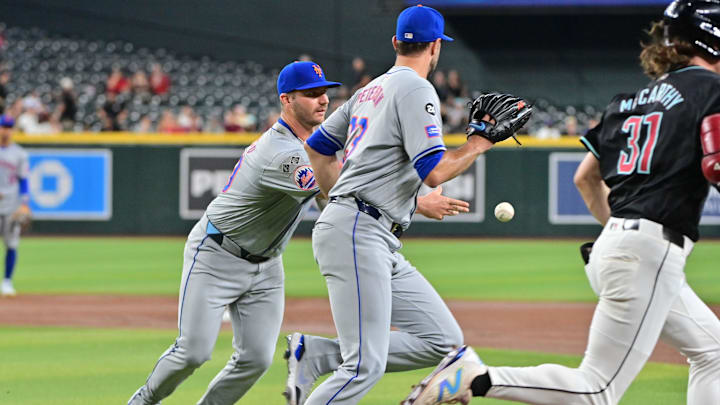 Aug 29, 2024; Phoenix, Arizona, USA;  New York Mets first base Pete Alonso (20) and pitcher David Peterson (23) race Arizona Diamondbacks outfielder Jake McCarthy (31) to first base in the fourth inning at Chase Field. Mandatory Credit: Matt Kartozian-USA TODAY Sports