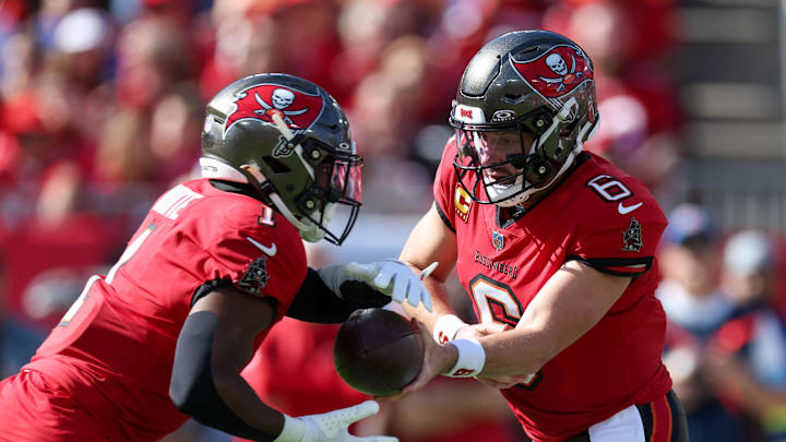 Dec 8, 2024; Tampa, Florida, USA; Tampa Bay Buccaneers quarterback Baker Mayfield (6) hands off to running back Rachaad White (1) against the Las Vegas Raiders in the first quarter at Raymond James Stadium. Mandatory Credit: Nathan Ray Seebeck-Imagn Images
