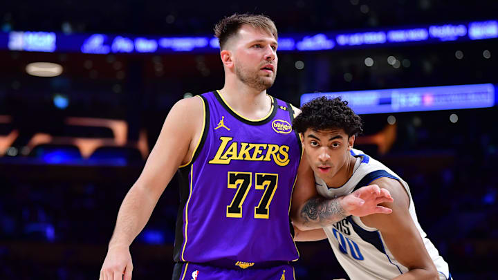 Feb 25, 2025; Los Angeles, California, USA; Los Angeles Lakers guard Luka Doncic (77) attempts to gain position on Dallas Mavericks guard Max Christie (00) during the second half at Crypto.com Arena. Mandatory Credit: Gary A. Vasquez-Imagn Images