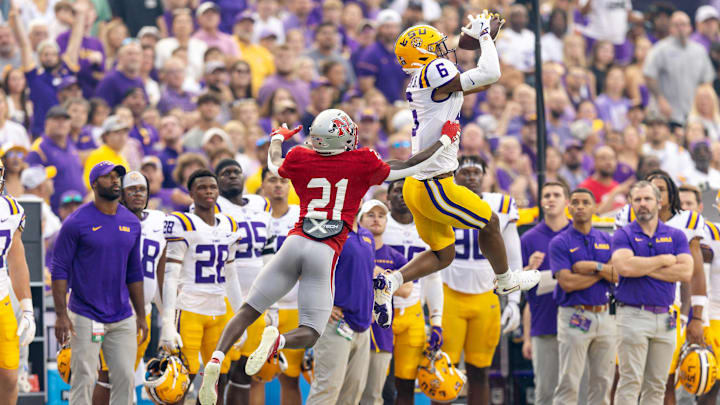 Sep 7, 2024; Baton Rouge, Louisiana, USA; LSU Tigers wide receiver Shelton Sampson Jr. (6) catches a pass but is pushed out of bounds but Nicholls State Colonels defensive back Malik Woodery (21) during the first half at Tiger Stadium. Mandatory Credit: Stephen Lew-Imagn Images Sep 7, 2024; Baton Rouge, Louisiana, USA; LSU Tigers wide receiver Shelton Sampson Jr. (6) catches a pass but is pushed out of bounds but Nicholls State Colonels defensive back Malik Woodery (21) during the first half at Tiger Stadium. Mandatory Credit: Stephen Lew-Imagn Images