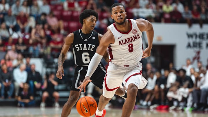 Feb 25, 2025; Tuscaloosa, Alabama, USA; Alabama Crimson Tide guard Chris Youngblood (8) drives against Mississippi State Bulldogs guard Dellquan Warren (6) and guard Riley Kugel (2) during the second half at Coleman Coliseum. Mandatory Credit: Will McLelland-Imagn Images