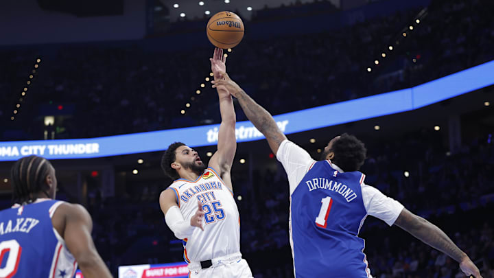 Dec 28, 2025; Oklahoma City, Oklahoma, USA; Oklahoma City Thunder guard Ajay Mitchell (25) shoots over Philadelphia 76ers center Andre Drummond (1) during the second half at Paycom Center. Mandatory Credit: Alonzo Adams-Imagn Images Dec 28, 2025; Oklahoma City, Oklahoma, USA; Oklahoma City Thunder guard Ajay Mitchell (25) shoots over Philadelphia 76ers center Andre Drummond (1) during the second half at Paycom Center. Mandatory Credit: Alonzo Adams-Imagn Images