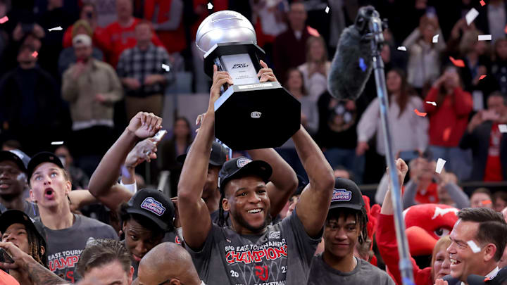 Mar 15, 2025; New York, NY, USA; St. John's basketball forward Zuby Ejiofor (24) hoists the championship trophy after defeating the Creighton Bluejays to win the Big East Tournament at Madison Square Garden.
