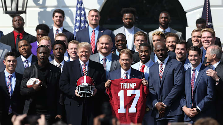 Apr 10, 2018; Washington, DC, USA; President Donald Trump (M) poses with Alabama Crimson Tide head coach Nick Saban a(M-R) and members of the Crimson Tide a ceremony honoring the college football playoff champion Crimson Tide on the South Lawn at the White House. Mandatory Credit: Geoff Burke-Imagn Images