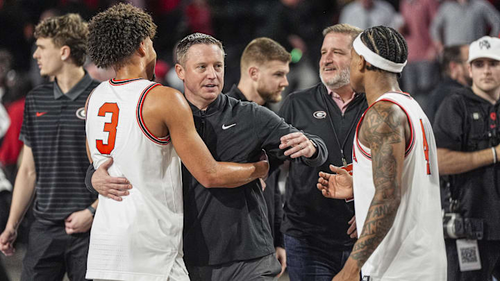 Jan 17, 2026; Athens, Georgia, USA; Georgia Bulldogs head coach Mike White reacts with guards Jordan Ross (3) and Marcus Millender (4) after Georgia defeated the Arkansas Razorbacks at Stegeman Coliseum. Mandatory Credit: Dale Zanine-Imagn Images