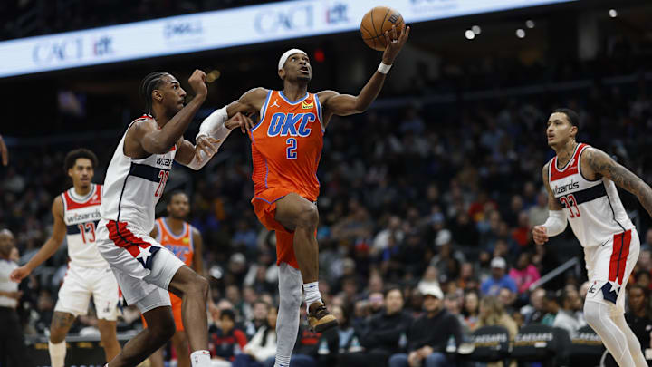 Jan 12, 2025; Washington, District of Columbia, USA; Oklahoma City Thunder guard Shai Gilgeous-Alexander (2) shoots the ball as Washington Wizards forward Alexandre Sarr (20) defends in the third quarter at Capital One Arena. Mandatory Credit: Geoff Burke-Imagn Images Jan 12, 2025; Washington, District of Columbia, USA; Oklahoma City Thunder guard Shai Gilgeous-Alexander (2) shoots the ball as Washington Wizards forward Alexandre Sarr (20) defends in the third quarter at Capital One Arena. Mandatory Credit: Geoff Burke-Imagn Images