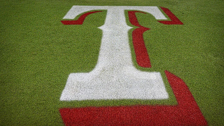 The Texas Rangers logo painted on the turf at Globe Life Field.