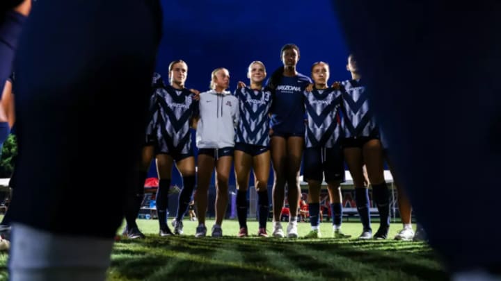 The Arizona soccer team huddled together before a match 