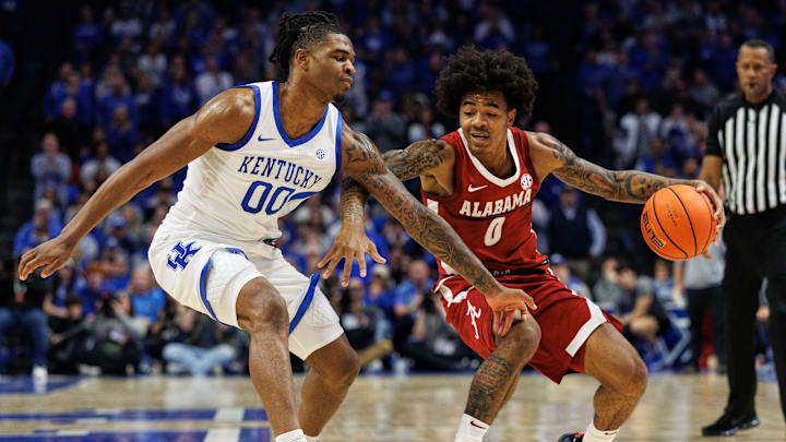 Jan 18, 2025; Lexington, Kentucky, USA; Alabama Crimson Tide guard Labaron Philon (0) dribbles the ball around Kentucky Wildcats guard Otega Oweh (00) during the first half at Rupp Arena at Central Bank Center. Mandatory Credit: Jordan Prather-Imagn Images