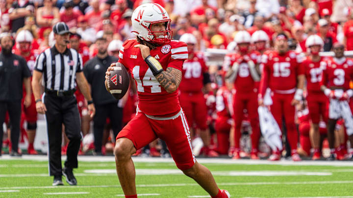 Sep 13, 2025; Lincoln, Nebraska, USA; Nebraska Cornhuskers quarterback TJ Lateef (14) scrambles against the Houston Christian Huskies during the third quarter at Memorial Stadium. Mandatory Credit: Dylan Widger-Imagn Images