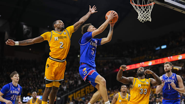 Dec 8, 2024; Columbia, Missouri, USA; Kansas Jayhawks guard Zeke Mayo (5) shoots the ball against Missouri Tigers guard Tamar Bates (2) and center Josh Gray (33) during the first half at Mizzou Arena. Mandatory Credit: Jay Biggerstaff-Imagn Images