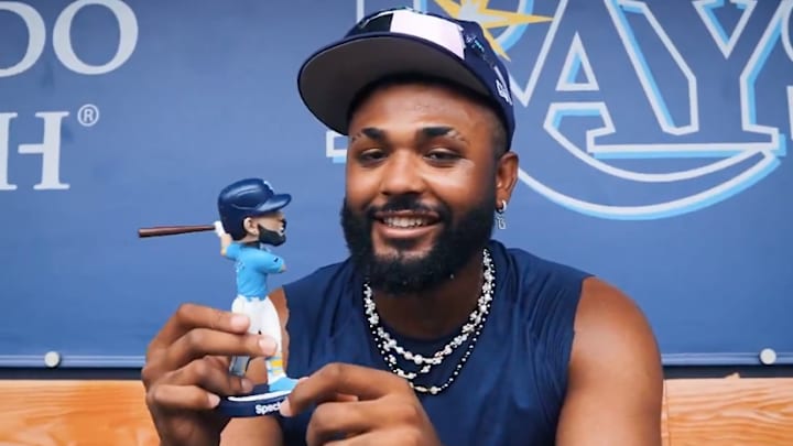 Tampa Bay third baseman Junior Caminero admires his bobblehead doll that was given out on Thursday. He hit a home run. Tampa Bay third baseman Junior Caminero admires his bobblehead doll that was given out on Thursday. He hit a home run.