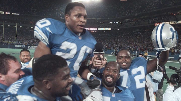 Detroit Lions running back Barry Sanders is carried on the shoulders of teammates after reaching the 2,000-yard milestone in 1997.