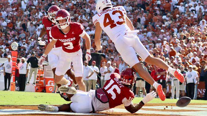 Oklahoma defender Danny Okoye blocks a punt by Texas' Mac Chiumento in Saturday' 27-24 OU victory in Dallas.