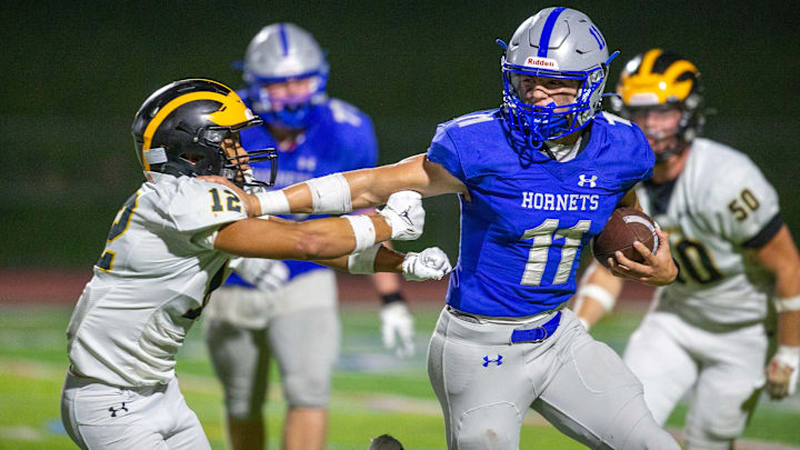 Holmdel quarterback Jack Cannon runs the ball around SJV's Victor Montalvo during the St. John Vianney vs. Holmdel football game at Holmdel High School in Holmdel, NJ Friday, September 13, 2024.