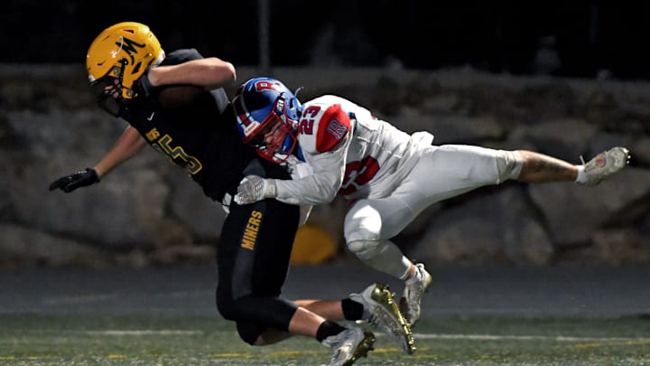 Reno's Chris Kosturos tackles Manogue's Kristian Ingman as he goes in to score during Monday's game at Bishop Manogue High School on Sept. 19, 2022.

Football Reno At Manogue 11