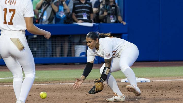 Jun 6, 2025; Oklahoma City, OK, USA;  Texas Longhorns utility Mia Scott (10) fields the ball in the fifth inning against the Texas Tech Red Raiders during game three of the NCAA Softball Women's College World Series finals at Devon Park. Mandatory Credit: Brett Rojo-Imagn Images
