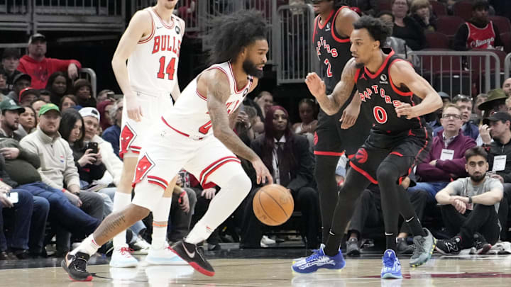 Apr 1, 2025; Chicago, Illinois, USA; Chicago Bulls guard Coby White (0) drives on Toronto Raptors guard A.J. Lawson (0) during the first quarter at United Center. Mandatory Credit: David Banks-Imagn Images
