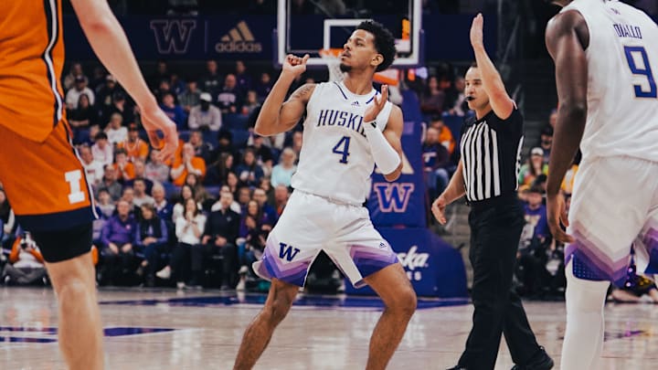 DJ Davis lands on the floor after launching a shot for the Huskies.