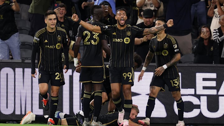Jul 30, 2024; Los Angeles, California, USA;  LAFC forward Denis Bouanga (99) celebrates a game tying goal by midfielder Mateusz Bogusz (19, bottom) during the second half against Vancouver Whitecaps FC at BMO Stadium. Mandatory Credit: Kiyoshi Mio-USA TODAY Sports