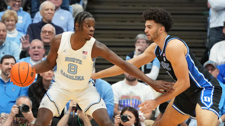 Feb 7, 2026; Chapel Hill, North Carolina, USA; North Carolina Tar Heels forward Caleb Wilson (8) with the ball as Duke Blue Devils forward Cameron Boozer (12) defends in the first  half at Dean E. Smith Center. Mandatory Credit: Bob Donnan-Imagn Images