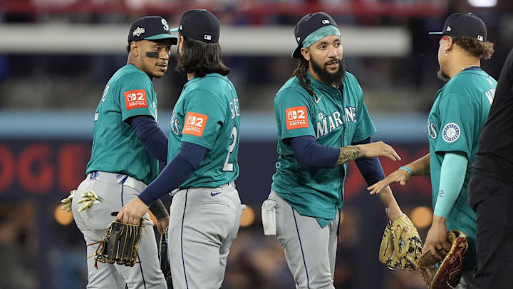Oct 12, 2025; Toronto, Ontario, CAN; Seattle Mariners second baseman Jorge Polanco (7) and third baseman Eugenio Suarez (28) and shortstop J.P. Crawford (3) celebrate with teammates after defeating the Toronto Blue Jays in game one of the ALCS round for the 2025 MLB playoffs at Rogers Centre.  Mandatory Credit: John E. Sokolowski-Imagn Images