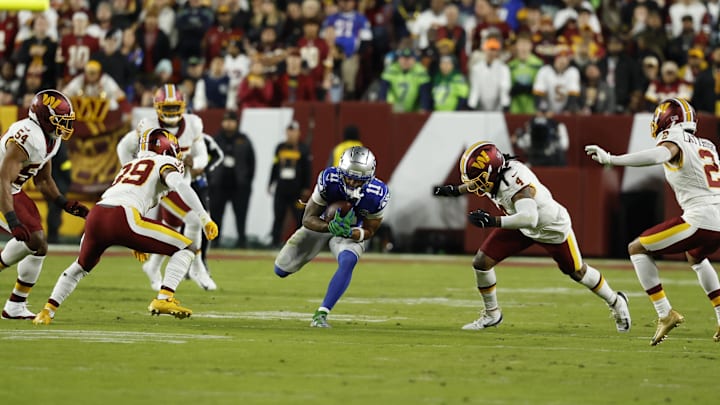 Nov 2, 2025; Landover, Maryland, USA;  Seattle Seahawks wide receiver Jaxon Smith-Njigba (11) runs with ball after making a catch defended by Washington Commanders linebacker Frankie Luvu (4) during the first quarter at Northwest Stadium. Mandatory Credit: Geoff Burke-Imagn Images
