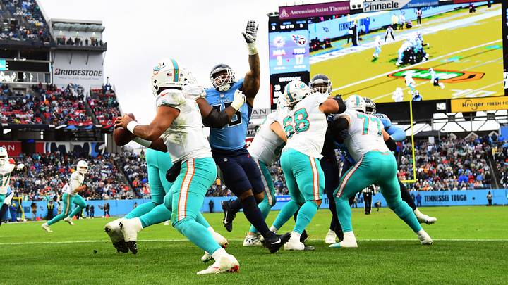 Miami Dolphins quarterback Tua Tagovailoa (1) scrambles in the pocket before pressure from Tennessee Titans defensive end Jeffery Simmons (98) during the second half at Nissan Stadium in the next-to-last game of the 2021 season. Miami Dolphins quarterback Tua Tagovailoa (1) scrambles in the pocket before pressure from Tennessee Titans defensive end Jeffery Simmons (98) during the second half at Nissan Stadium in the next-to-last game of the 2021 season.