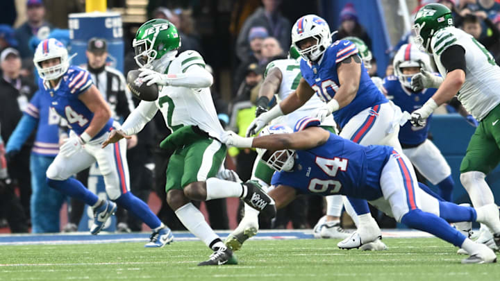 Dec 29, 2024; Orchard Park, New York, USA; Buffalo Bills defensive end Dawuane Smoot (94) grabs at New York Jets quarterback Tyrod Taylor (2) in the fourth quarter at Highmark Stadium